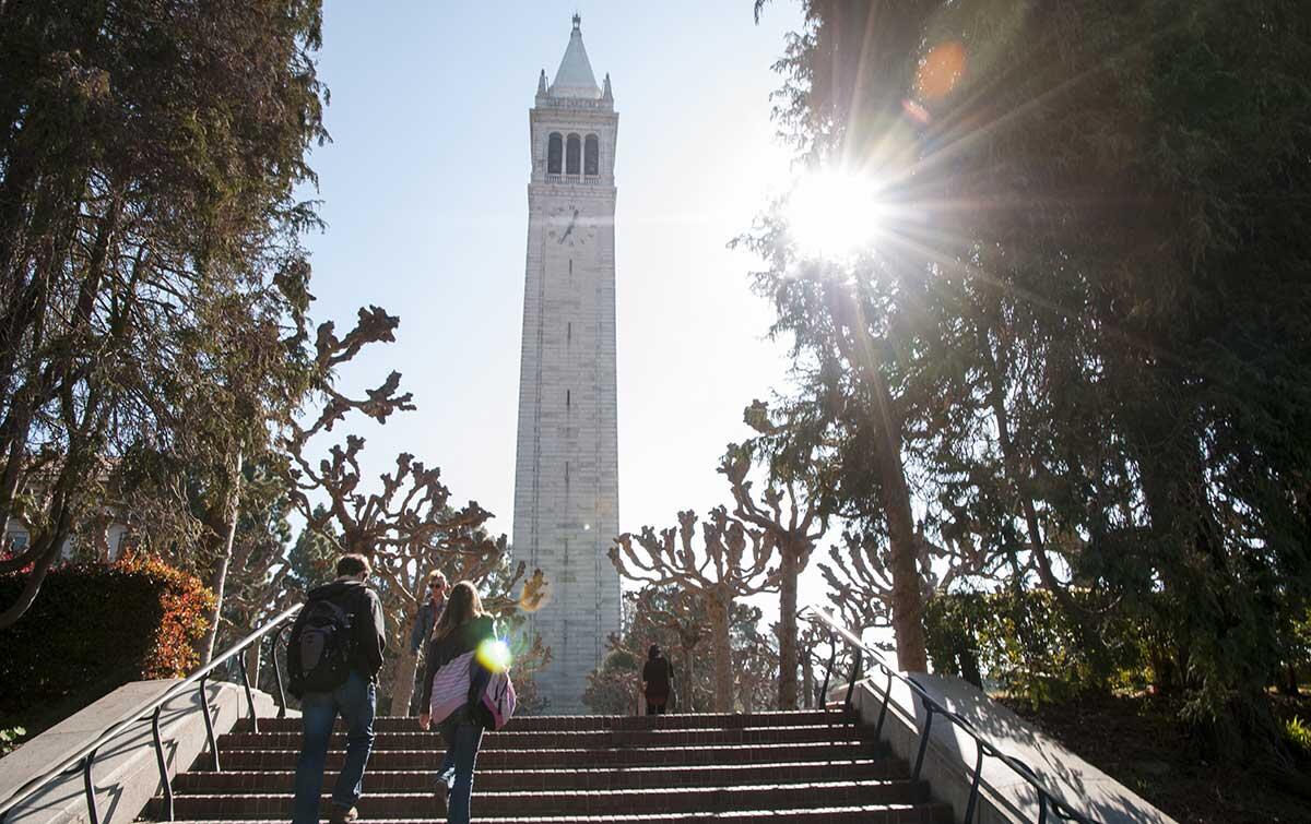 Student walking up stairs on campus.