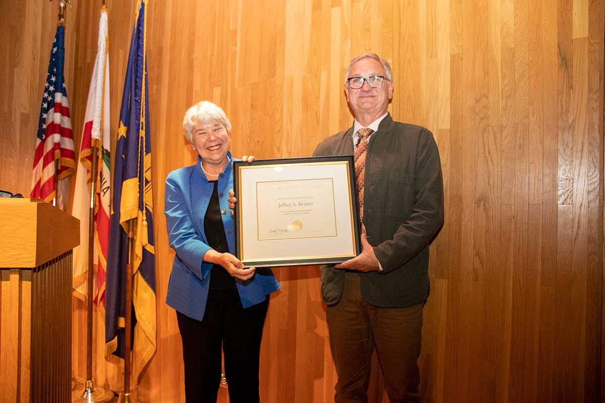 Chancellor Carol Christ presents Professor Jeffrey Reimer the Berkeley Citation