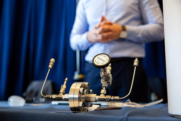 A carbon capture membrane system device is displayed on the Flux Technology table during the Berkeley SkyDeck Demo Day.