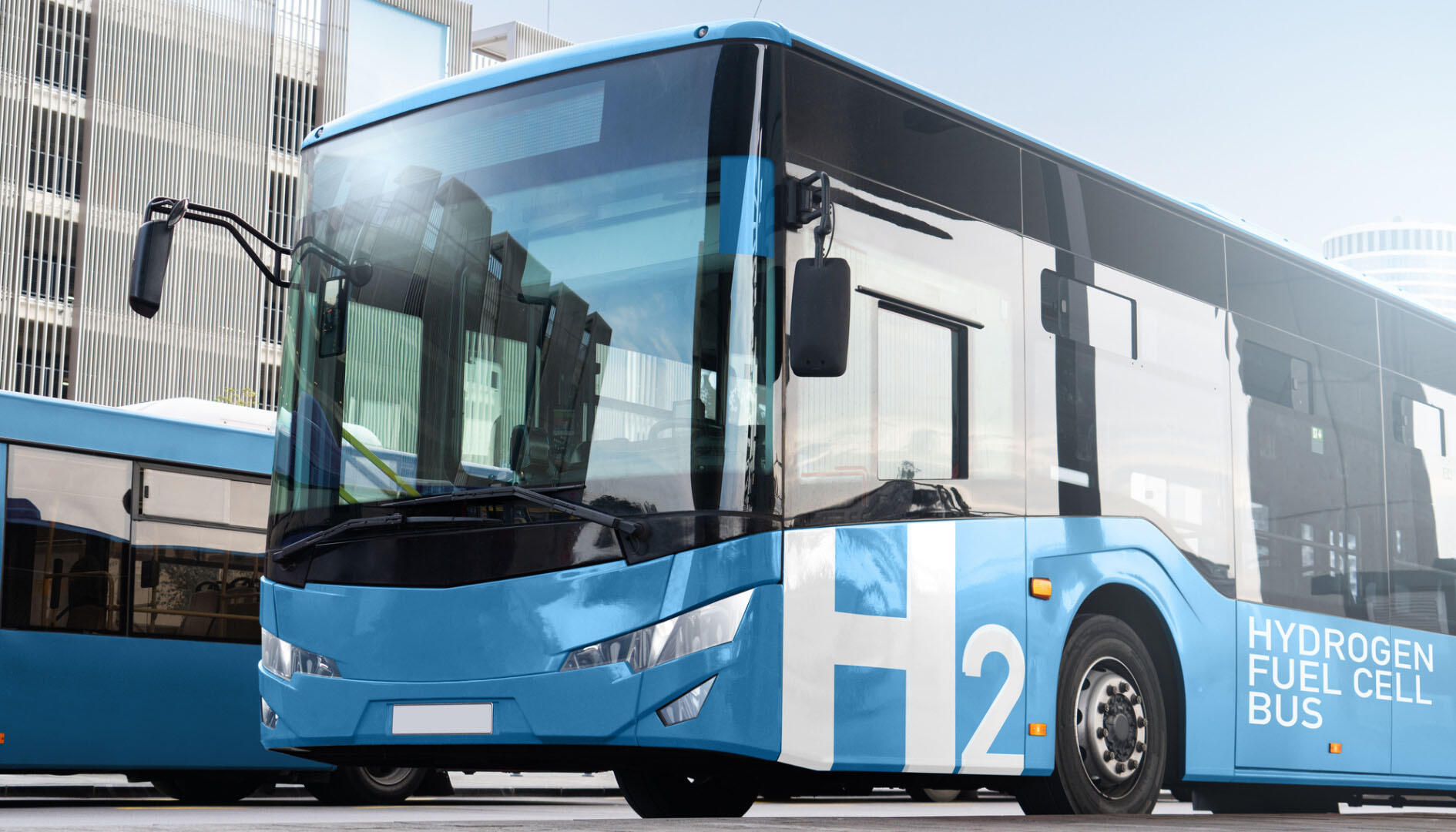 blue and white bus with 'H2' and 'Hydrogen fuel cell bus' written on side