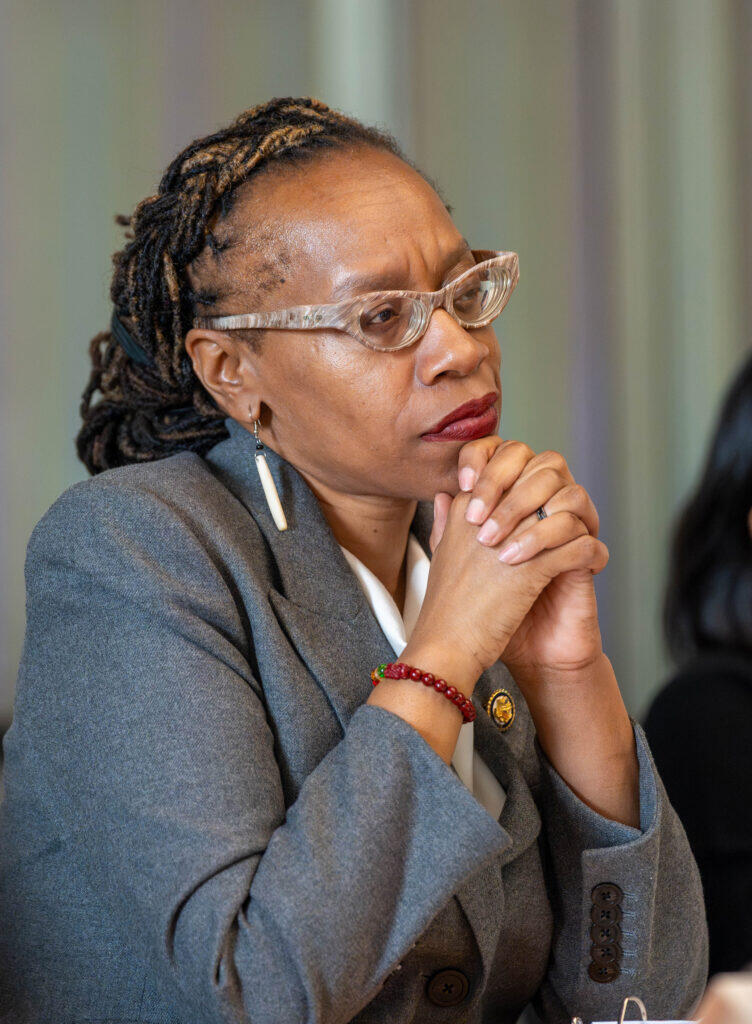 Woman with glasses looking intently into the distance.