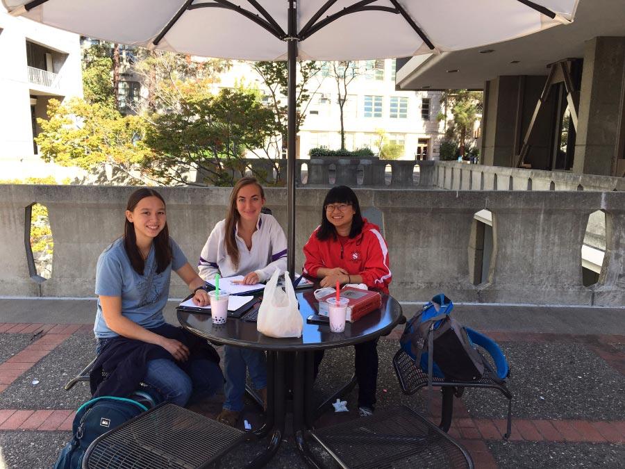 Students enjoying the CoC Plaza tables