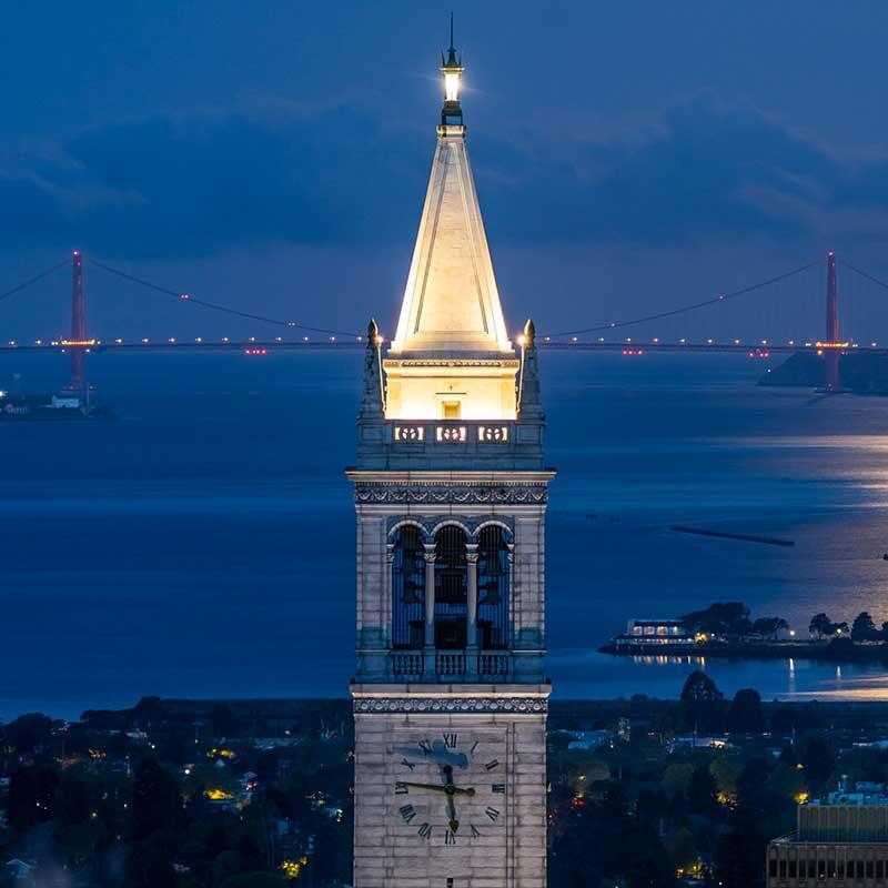 campanile lit during a full moon