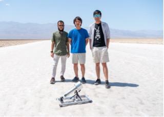 Study authors Ali Alawadhi, Woochul Song, and Zhiling Zheng stand behind the MOF-powered water havester in Death Valley National Park. (Photo courtesy of Omar Yaghi)